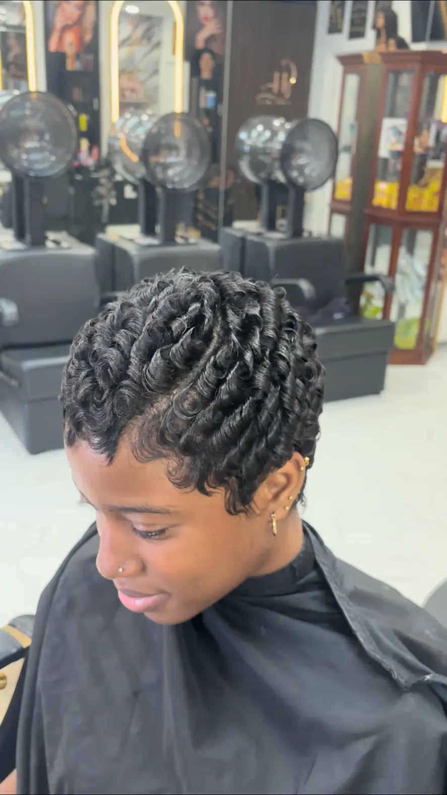 Short tapered cut with soft defined finger curls at Carmie Hair